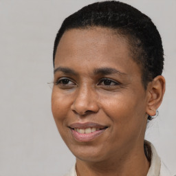 Joyful black adult female with short  brown hair and brown eyes