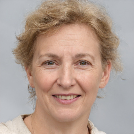 Joyful white adult female with medium  brown hair and blue eyes