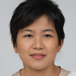 Joyful asian young-adult female with short  brown hair and brown eyes