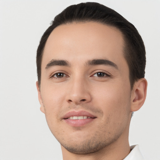 Joyful white young-adult male with short  black hair and brown eyes