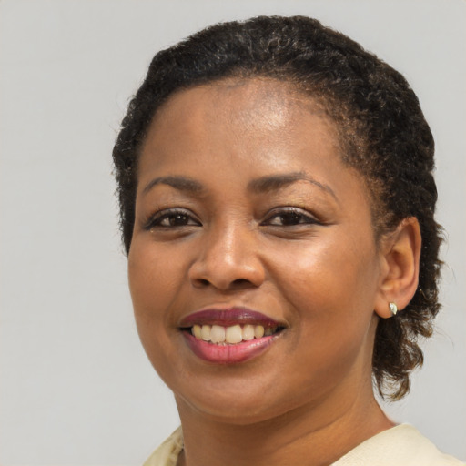 Joyful black young-adult female with medium  brown hair and brown eyes