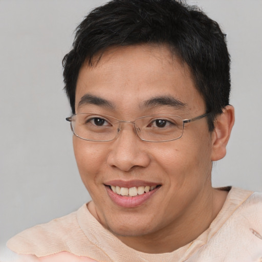 Joyful asian young-adult male with short  brown hair and brown eyes