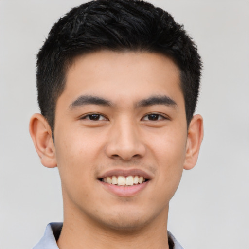 Joyful asian young-adult male with short  black hair and brown eyes