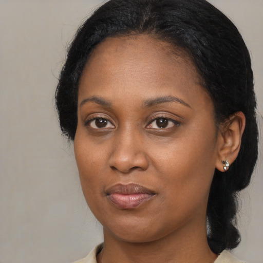 Joyful black young-adult female with medium  brown hair and brown eyes