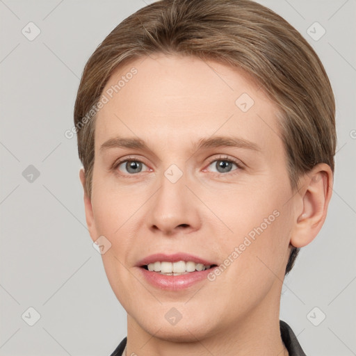 Joyful white young-adult female with short  brown hair and grey eyes