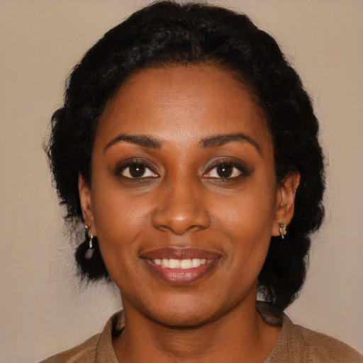 Joyful black young-adult female with medium  black hair and brown eyes