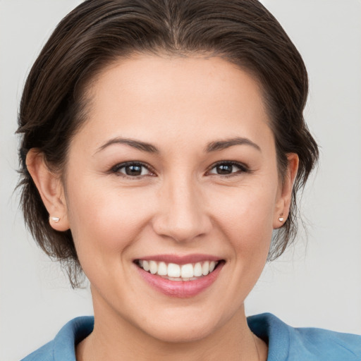 Joyful white young-adult female with medium  brown hair and brown eyes