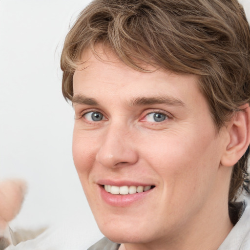 Joyful white young-adult female with medium  brown hair and blue eyes