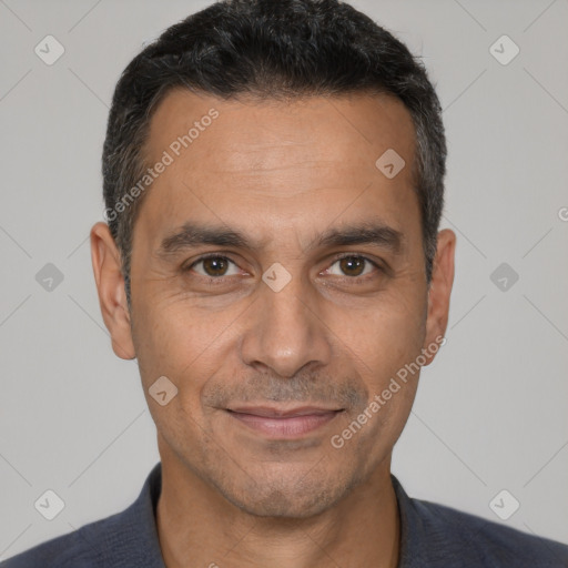 Joyful white adult male with short  black hair and brown eyes