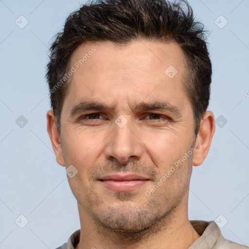 Joyful white adult male with short  brown hair and brown eyes