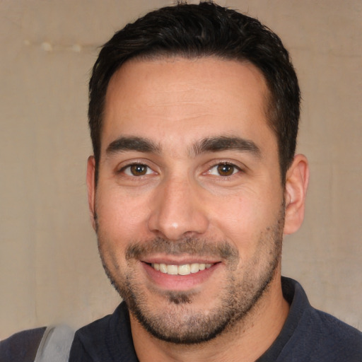 Joyful white young-adult male with short  black hair and brown eyes