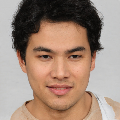 Joyful asian young-adult male with short  brown hair and brown eyes