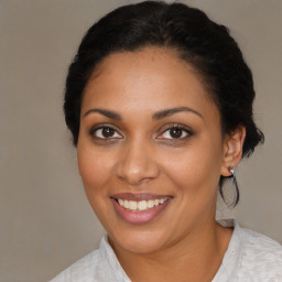 Joyful black young-adult female with medium  brown hair and brown eyes