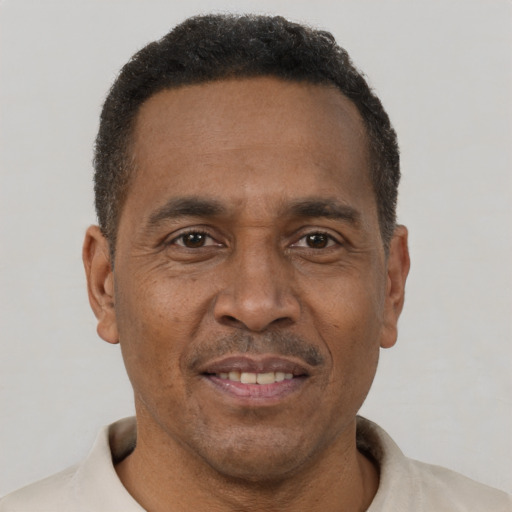 Joyful black adult male with short  brown hair and brown eyes