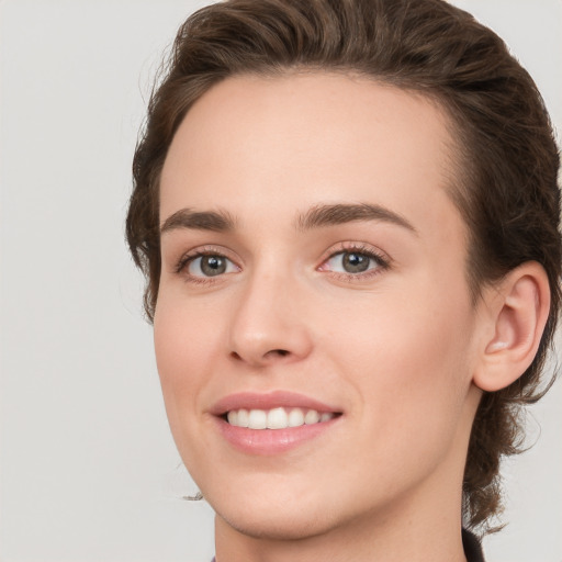 Joyful white young-adult female with medium  brown hair and green eyes