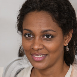 Joyful black young-adult female with medium  brown hair and brown eyes