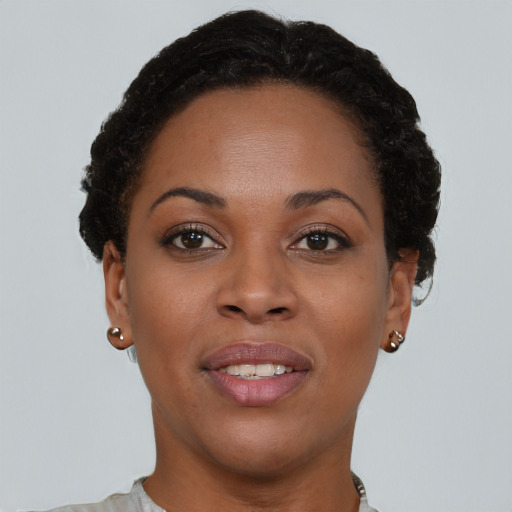 Joyful black young-adult female with short  brown hair and brown eyes