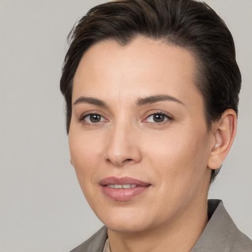 Joyful white young-adult female with short  brown hair and brown eyes