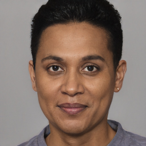 Joyful black adult male with short  black hair and brown eyes