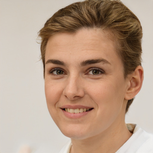 Joyful white young-adult female with short  brown hair and brown eyes