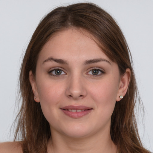 Joyful white young-adult female with long  brown hair and grey eyes