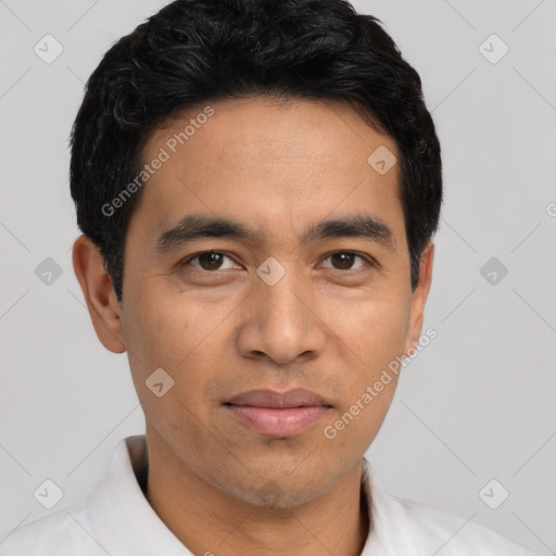 Joyful asian young-adult male with short  black hair and brown eyes