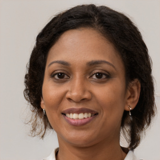 Joyful black young-adult female with medium  brown hair and brown eyes