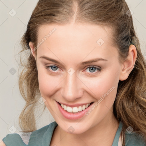 Joyful white young-adult female with medium  brown hair and blue eyes