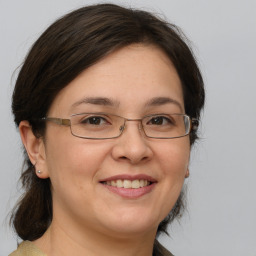 Joyful white adult female with medium  brown hair and brown eyes