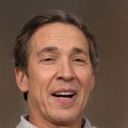 Joyful white middle-aged male with short  brown hair and brown eyes