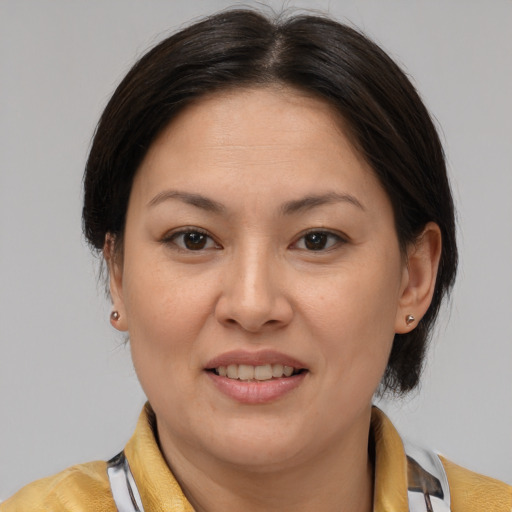 Joyful latino adult female with medium  brown hair and brown eyes