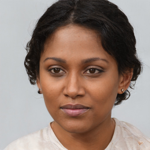 Joyful black young-adult female with medium  brown hair and brown eyes