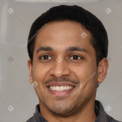 Joyful latino young-adult male with short  black hair and brown eyes