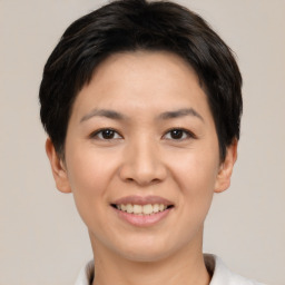 Joyful asian young-adult female with short  black hair and brown eyes