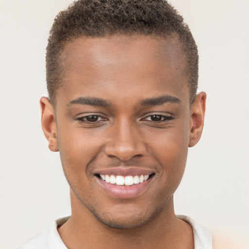 Joyful black young-adult male with short  brown hair and brown eyes