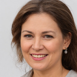 Joyful white adult female with medium  brown hair and brown eyes