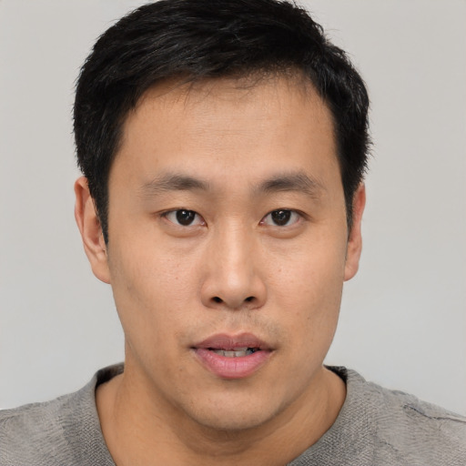Neutral asian young-adult male with short  black hair and brown eyes