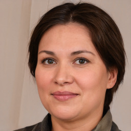 Joyful white adult female with medium  brown hair and brown eyes