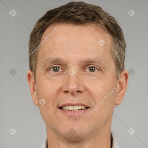 Joyful white adult male with short  brown hair and brown eyes