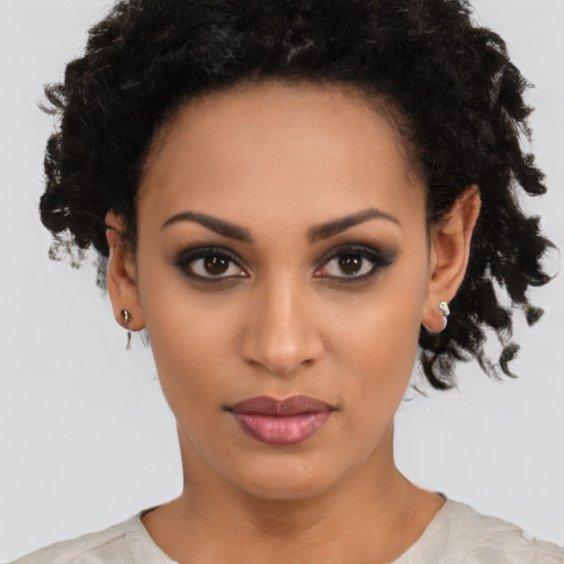 Joyful latino young-adult female with short  black hair and brown eyes