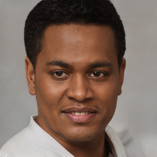 Joyful latino young-adult male with short  brown hair and brown eyes