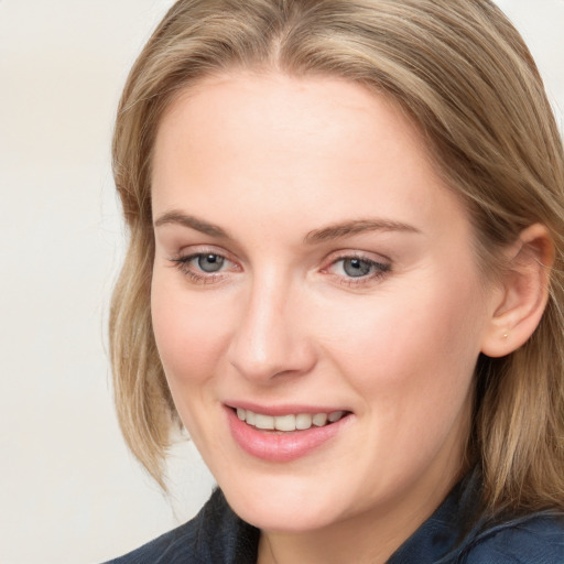 Joyful white young-adult female with long  brown hair and blue eyes