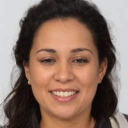 Joyful white adult female with long  brown hair and brown eyes