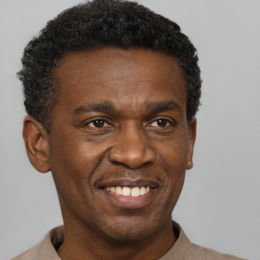 Joyful black young-adult male with short  black hair and brown eyes