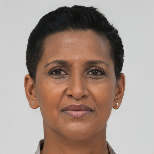 Joyful black adult female with short  black hair and brown eyes