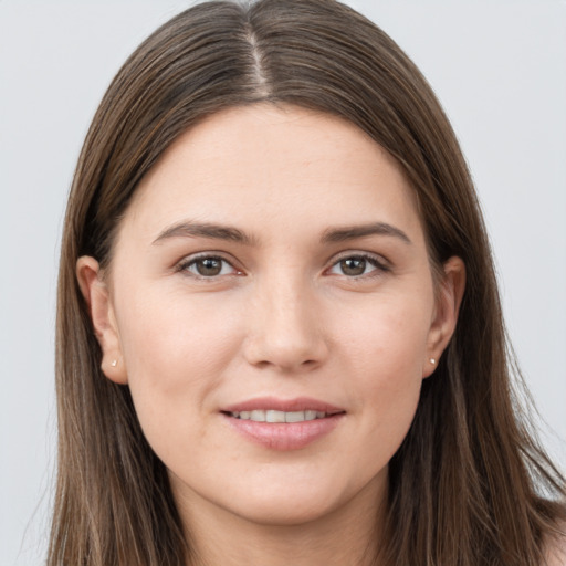 Joyful white young-adult female with long  brown hair and grey eyes