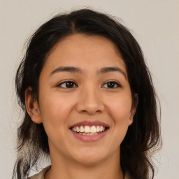 Joyful latino young-adult female with medium  brown hair and brown eyes