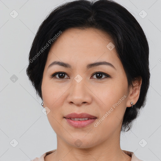 Joyful asian adult female with medium  brown hair and brown eyes