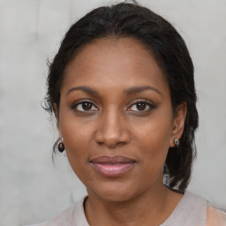 Joyful black young-adult female with medium  brown hair and brown eyes