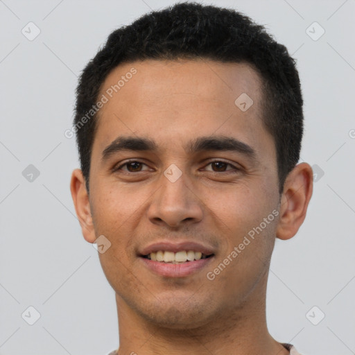 Joyful latino young-adult male with short  brown hair and brown eyes